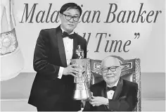  ??  ?? Dr KK Johan (left) presents the award trophy to Teh. Teh has been awarded the ‘The Greatest Malaysian Banker of All Time’ by the Asia Pacific Brands Foundation recently, during the Public Bank Management Seminar Dinner held at the Mines Internatio­nal...