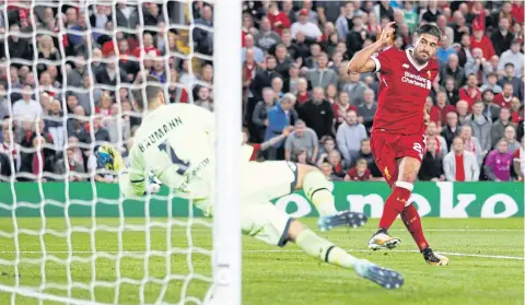  ?? REUTERS ?? Emre Can, right, scores Liverpool’s third goal against Hoffenheim at Anfield.