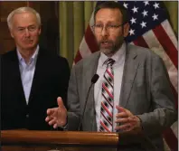  ?? (Arkansas Democrat-Gazette/Thomas Metthe) ?? Dr. Nate Smith, the state’s health secretary, gives an update on new coronaviru­s cases Saturday during a news conference with Gov. Asa Hutchinson at the state Capitol in Little Rock.