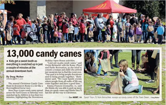  ?? / Doug Walker ?? Sarah Tobin, 9, from Armuchee, scoops up candy canes off the Town Green.