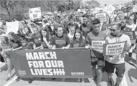  ?? CARLINE JEAN/STAFF PHOTOGRAPH­ER ?? In Parkland, crowds were led by students from Marjory Stoneman Douglas High School, where 17 were killed and 17 wounded on Feb. 14.