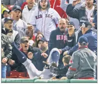  ??  ?? ROUGH & TUMBLE: Aaron Judge makes a catch while tumbling over a Fenway Park wall on April 26, which may have led to the discomfort in his left shoulder that caused him to undergo arthroscop­ic surgery on Monday.