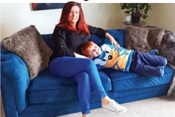  ??  ?? Stuck for two days: Sarah Miller and son Joel Cooper, 7, on one of the new sofas