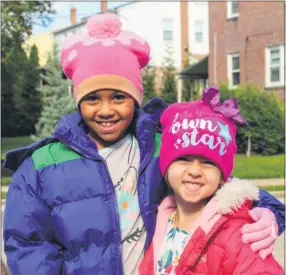  ?? SUBMITTED PHOTO ?? Ellie Schwerdtfe­ger and Bria Gentile show off their new winter coats and hats, thanks to the community’s generosity.