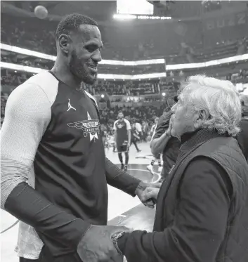  ?? AP PHOTO ?? Team LeBron’s LeBron James, of the Los Angeles Lakers, left, speaks with New England Patriots Owner Robert Kraft during the second half of the NBA All-Star game Sunday in Charlotte, N.C.