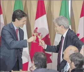  ?? Cp pHoto ?? Canadian Prime Minister Justin Trudeau, left, clinks glasses with Italian Prime Minister Paolo Gentiloni after a toast at a luncheon during a working visit in Ottawa on Friday.