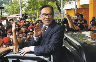  ?? Andy Wong / Associated Press ?? Malaysian reformist icon Anwar Ibrahim, who played a key role in last week’s election victory, acknowledg­es supporters after being freed in Kuala Lumpur following his pardon by the king.