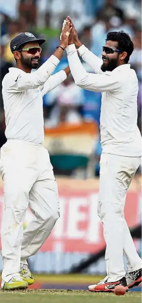  ?? — AFP ?? Joyous day: Indian bowler Ravindra Jadeja (right) celebrates with teammate Ajinkya Rahane after running out Australian batsman Josh Hazlewood on the second day of the third Test match in Ranchi yesterday.