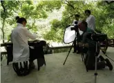  ??  ?? Making a simple video of a guzheng player in Chongqing, China, with sound: camera locked off, fixed focal length lens, mic with windshield mounted on camera and sound fed to camera