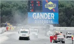  ?? MATT SLOCUM, THE ASSOCIATED PRESS ?? Track workers repair a section of fence after a wreck during the IndyCar race at Pocono Raceway on Sunday.