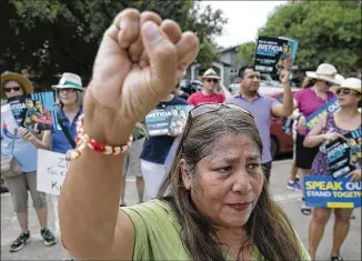  ?? RALPH BARRERA / AMERICAN-STATESMAN ?? Marian Vasquez’s wrist is adorned with a bracelet given to her by a young girl in a detention center in San Benito as she protests Austin nonprofit Southwest Key’s operation of facilities for immigrant children who were separated from parents at the U.S.-Mexico border.