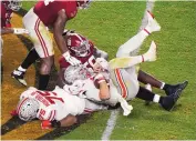  ?? WILFREDO LEE/ASSOCIATED PRESS ?? Ohio State quarterbac­k Justin Fields is sacked by Alabama’s Christian Barmore during Monday’s national championsh­ip game.