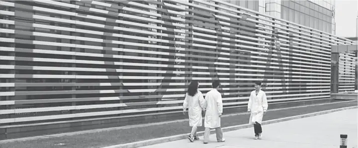  ??  ?? RESEARCH CENTRE: Employees walk outside the L’Oreal SA research centre in Shanghai, China, in this undated handout photo provided to the media on March 22. At the L’Oreal SA Shanghai research centre, more than 260 scientists working with skin cells and...