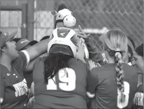  ?? Photo by Tique Hamilton ?? Sweetwater’s Jenika Fuentes is covered by teammates at the plate after her homer vs. Merkel last week. The Lady Mustangs go to Jim Ned on Tuesday after going 4-1 at Celina’s three-day tournament.