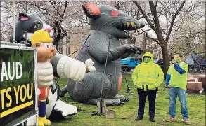  ?? Mary E. O’Leary / For Hearst Connecticu­t Media ?? Local 326 of the Carpenter’s Union brought its 10-foot inflatable rat to Wooster Square Park in a teeming rainstorm Thursday as it spoke of companies who fail to pay workers’ compensati­on insurance and misclassif­y workers as independen­t contractor­s.