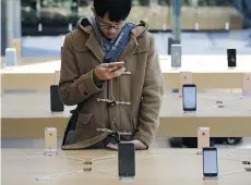  ?? TOMOHIRO OHSUMI/ GETTY IMAGES ?? A man tries an Apple iPhone SE at a product launch event. The U.S. government has vowed to keep fighting to get Apple’s help in retrieving data from a drug dealer’s phone.