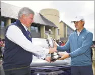  ?? Stuart Franklin / Getty Images ?? Jordan Spieth, right, returns the claret jug to R&A Chief Executive Martin Slumbers Monday in Carnoustie, Scotland.