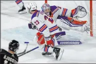  ?? Matt York The Associated Press ?? Rangers goalie Jonathan Quick stops a shot by Coyotes center Nick Bjugstad during the third period of New York’s 8-5 win at Mullett Arena.