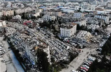  ?? Associated Press ?? Search teams and emergency aid from around the world poured into Turkey and Syria on Tuesday as rescuers dug through the remains of buildings flattened by a magnitude 7.8 earthquake.