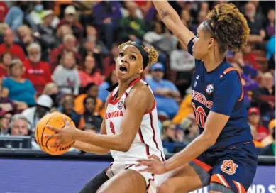  ?? AP PHOTO BY MIC SMITH ?? Georgia’s Diamond Battles, left, goes in for a layup against Auburn’s Sydney Shaw during a second-round game at the SEC tournament Thursday in Greenville, S.C.