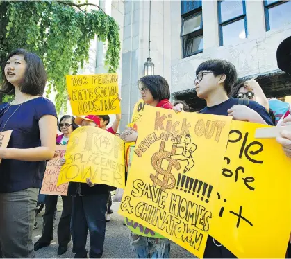  ?? MARK VAN MANEN ?? People gathered outside of Vancouver’s City Hall to show their concerns over a large developmen­t at 105 Keefer street — land they believe should be used to house Chinatown seniors.