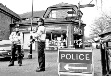  ??  ?? In this file photo show police officers stand on duty at a cordon near a bench covered in a protective tent at The Maltings shopping centre in Salisbury, southern England, where Ex-Russian spy Sergei Skripal and his daughter Yulia were found critically ill on March 4, after being apparently poisoned with what was later identified as a nerve agent sparking a major incident. — AFP photo