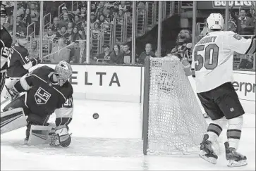  ?? Reed Saxon Associated Press ?? KINGS GOALTENDER Darcy Kuemper can’t stop a shot by San Jose center Chris Tierney (50) in the first period, his 11th goal and the first for the Sharks on the way to a 4-1 victory at Staples Center.