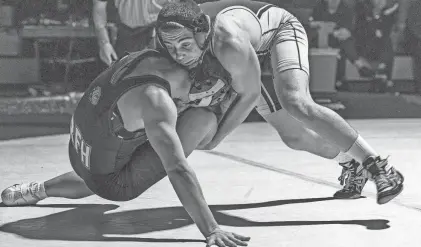  ?? PETER ACKERMAN ?? St. John Vianney’s John Saraiva, right, defeated Rumson-Fair Haven’s Evan Ridgway 11-9 in the 165-pound bout Wednesday night. St. John Vianney won the match 44-26.