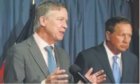  ?? Mark Wilson, Getty Images ?? Colorado Gov. John Hickenloop­er, left, and Ohio Gov. John Kasich participat­e in a bipartisan news conference to discuss the Senate health care reform bill at the National Press Club in Washington, D.C., in June.