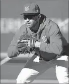  ?? PATRICK SEMANSKY/AP ?? Nationals second baseman Brian Dozier gets ready to field a grounder during a workout Friday at Nationals Park.