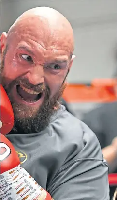  ?? Pictures: Getty. ?? American Deontay Wilder, top, and Britain’s Tyson Fury, left, work out in the gym ahead of their world heavyweigh­t fight in Los Angeles tonight.