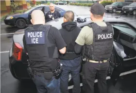  ?? Charles Reed / Immigratio­n and Customs Enforcemen­t 2017 ?? Agents with Immigratio­n and Customs Enforcemen­t arrest a suspect in 2017 in Los Angeles. Disputes over curbs on the agency were a focus in budget talks.