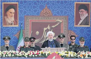  ?? AP ?? President Hassan Rouhani speaks at a military parade marking the 39th anniversar­y of the outset of the Iran-Iraq war outside Tehran yesterday.