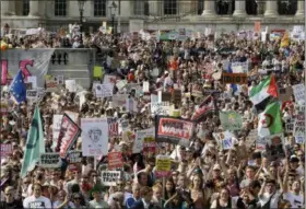  ?? TIM IRELAND — THE ASSOCIATED PRESS ?? Protesters holding banners gather after a march opposed to the visit of U.S. President Donald Trump in Trafalgar Square in London, Friday.