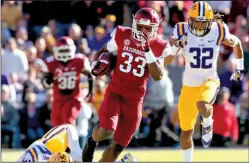  ??  ?? Arkansas Democrat-Gazette/BENJAMIN KRAIN
Sophomore Korliss Marshall (33), who spent much of last season at safety, sophomore Alex Colllins and junior Jonathan Williams give Arkansas a three-tiered rushing attack.