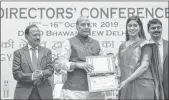  ??  ?? Union Defence Minister Rajnath Singh presents an award to young scientist Surabhi Singh in New Delhi