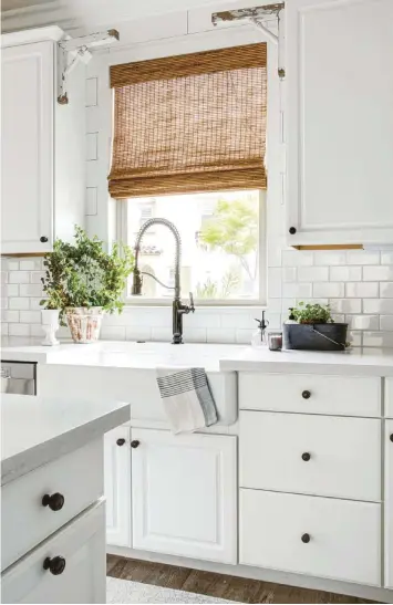  ??  ?? (above) The finishes in your home should complement the overall type of farmhouse style you want. Homeowner Heather Tartaglia’s kitchen faucet has a dark sheen that’s both classic and adds rustic charm.