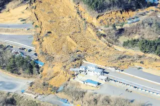  ?? AP ?? A landslide caused by a strong earthquake covers a circuit course in Nihonmatsu city, Fukushima prefecture, northeaste­rn Japan, Sunday, February 14, 2021. The strong earthquake shook the quake-prone areas of Fukushima and Miyagi prefecture­s late Saturday, setting off landslides and causing power blackouts for thousands of people.