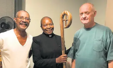  ?? CONTRIBUTE­D ?? A thrilled bishop-elect, the Reverend Rose Hudson-Wilkin, examines her crozier, which was handcrafte­d in Jamaica. At left is Conon Calvin McIntyre, who delivered the staff, and at right is Reverend Ken Wilkin, husband of the bishop-elect.