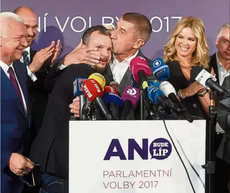  ??  ?? Victory peck: Babis kissing ANO social media public relations manager Marek Prchal at their headquarte­rs after Czech elections. — AFP