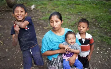  ??  ?? Claudia Maquin holds her six-month daughter Angela next to her other children, Abdel (left), 9, and Elvis, 5, at her house in San Antonio Seacortez village, in Raxruha municipali­ty. — AFP photo