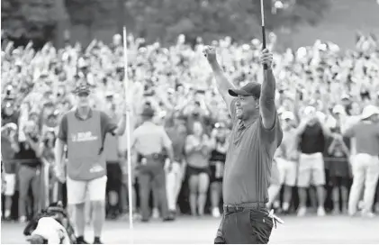  ?? HYOSUB SHIN/ASSOCIATED PRESS ?? Tiger Woods celebrates after winning the Tour Championsh­ip golf tournament in Atlanta in September for his 80th career PGA Tour win.