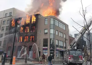  ?? GIUSEPPE VALIANTE/THE CANADIAN PRESS ?? Firefighte­rs couldn’t stop a full-out blaze from destroying the Robillard building in the Chinatown district in November, and the asbestos-filled ruin has yet to be cleaned up.