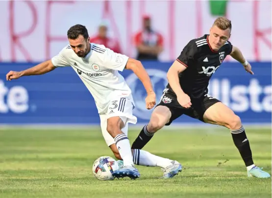  ?? CHICAGO FIRE FC ?? Fire defender Jonathan Bornstein controls the ball against D.C. United defender Julian Gressel in the first half Saturday at Soldier Field.