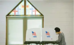  ?? TRENT SPRAGUE/AP ?? A voter casts a ballot at Bayside Presbyteri­an Church in Virginia Beach on June 8, 2021.