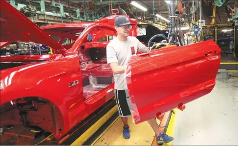  ?? REBECCA COOK / REUTERS ?? A Ford Motor worker assembles a Mustang at the company’s plant in Flat Rock, Michigan, on Aug 20, 2015.