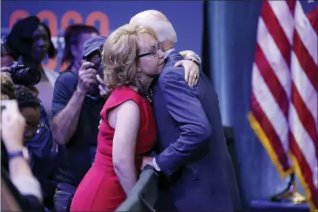  ?? JOHN LOCHER — THE ASSOCIATED PRESS ?? Former Vice President and Democratic presidenti­al candidate Joe Biden, right, hugs former Rep. Gabby Giffords during a gun safety forum Wednesday in Las Vegas.