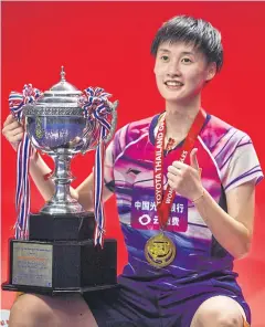  ?? AFP ?? Chen Yufei poses with the trophy during the award presentati­on.