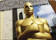  ?? PHOTO BY MATT SAYLES/INVISION/AP ?? In this Feb. 21, 2015, file photo, an Oscar statue appears outside the Dolby Theatre for the 87th Academy Awards in Los Angeles. The 93rd Oscars will be held on April 25.