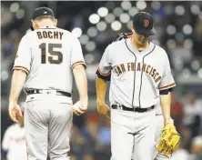  ?? Mike Zarrilli / Getty Images ?? Manager Bruce Bochy takes the ball from Matt Cain, who allowed seven runs and 10 hits in four-plus innings.